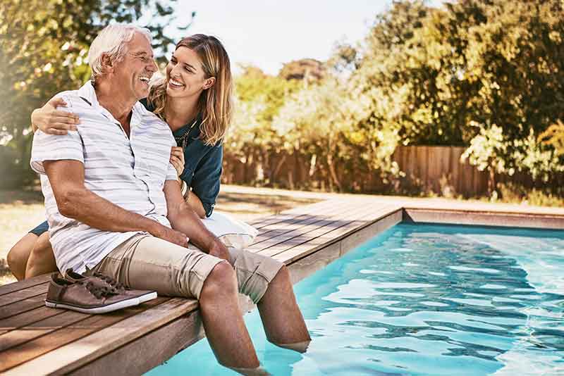 father with hearing loss and daughter by pool
