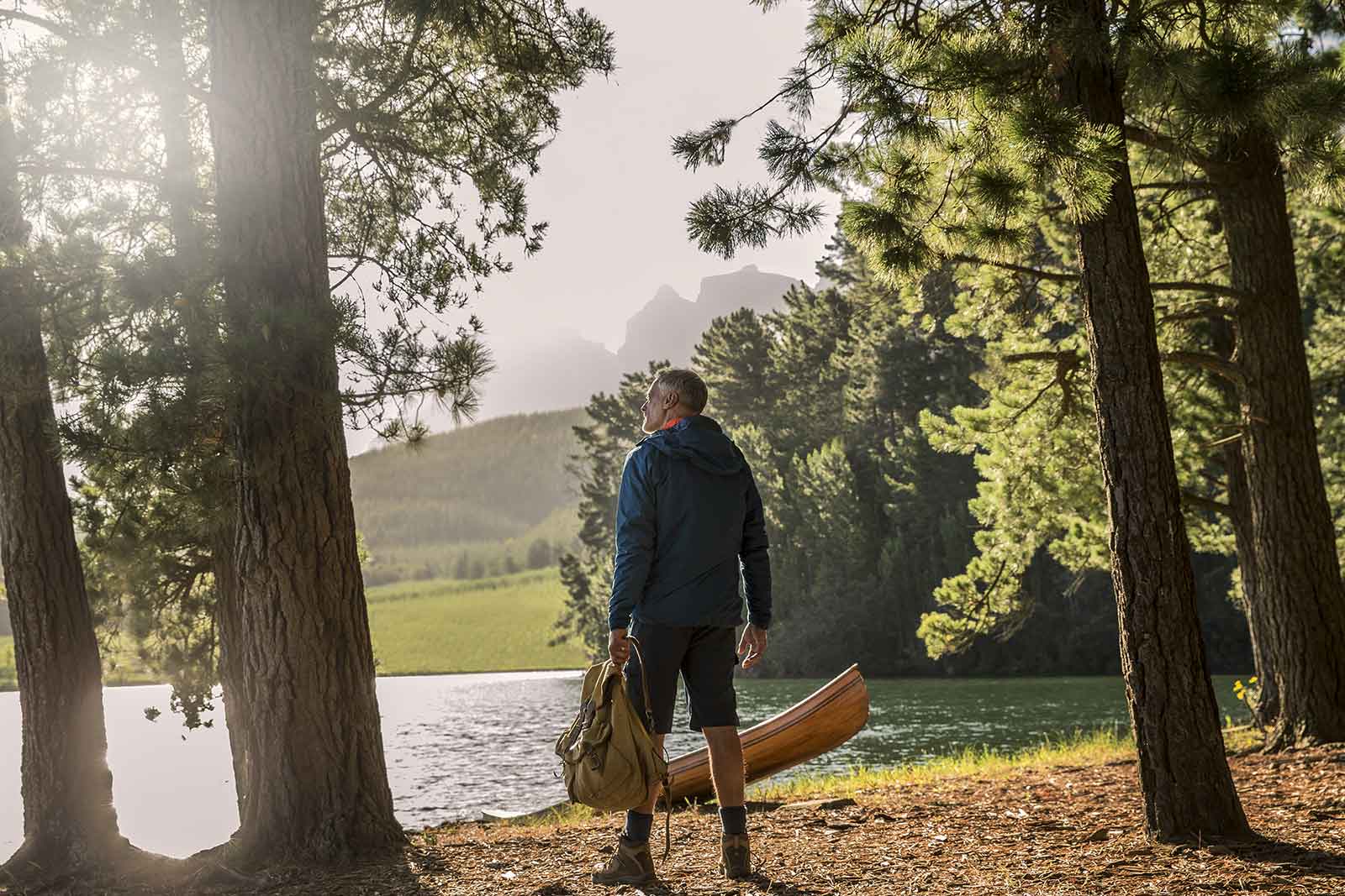 Man wearing hearing aids going kayaking in nature